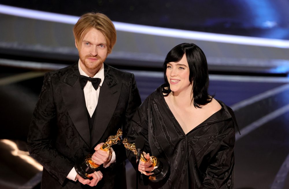 Billie Eilish and Finneas O'Connell accepting their award at the Oscars 2022 for No Time To Die